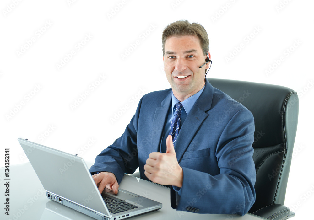 Business man on a call while working on laptop and giving big thumbs up or customer service representative helping people with thumbs up Business man on a call while working on laptop and giving big thumbs up or customer service representative helping people with thumbs up