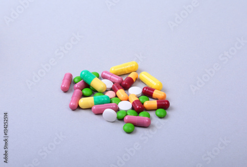 Pills and medical thermometer on white background. .