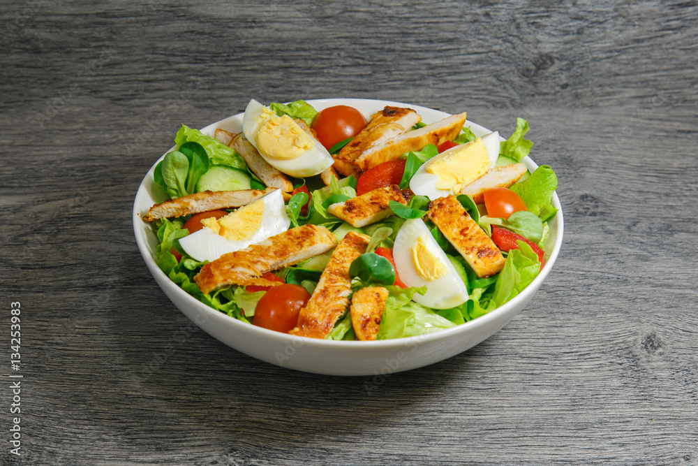 Grilled chicken salad with lettuce, tomatoes and eggs Grilled chicken salad with lettuce, tomatoes and eggs