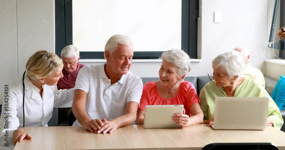 Female doctor interacting with senior citizens Female doctor interacting with senior citizens