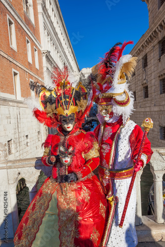 Carnival masks against famous Bridge of Sighs in Venice, Italy