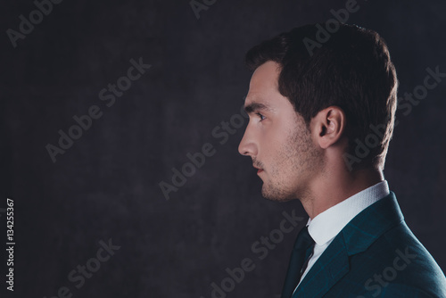 Side view portrait of handsome bearded man in suit