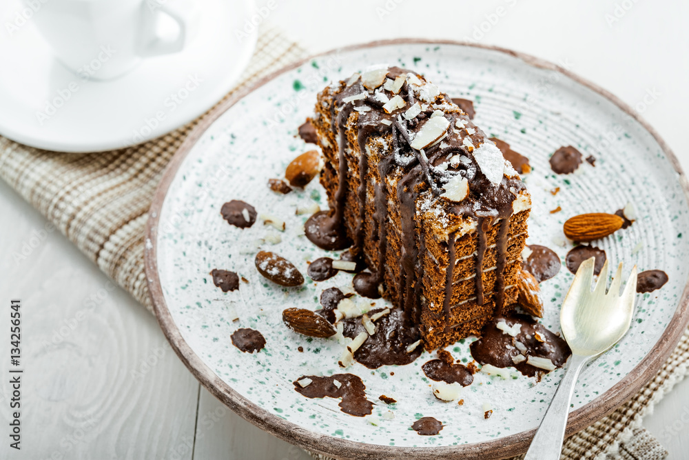 Piece of chocolate Spartak cake on a table. Delicious sweet food on a beautiful plate. Top view. Piece of chocolate Spartak cake on a table. Delicious sweet food on a beautiful plate. Top view.