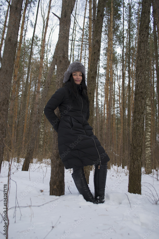 girl in a fur coat in the winter in the Park the sun girl in a fur coat in the winter in the Park the sun
