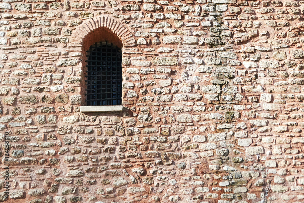 window porthole with a black grille in the wall