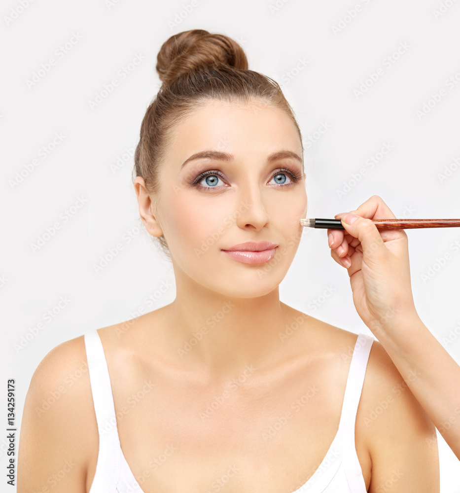 Applying Make-up. Woman with a brush for make-up Applying Make-up. Woman with a brush for make-up