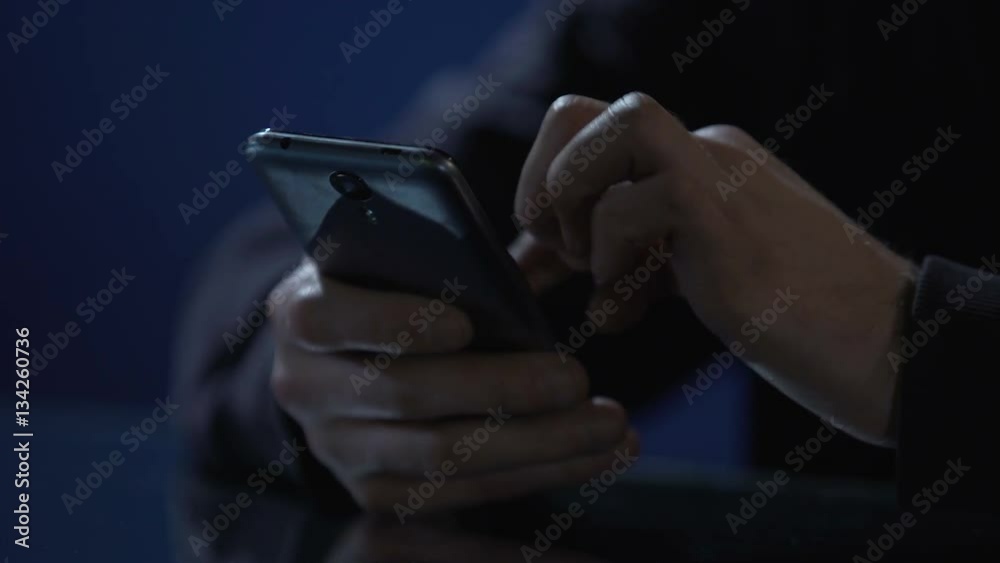 Hands of lonely man scrolling pictures on smartphone, using mobile dating app