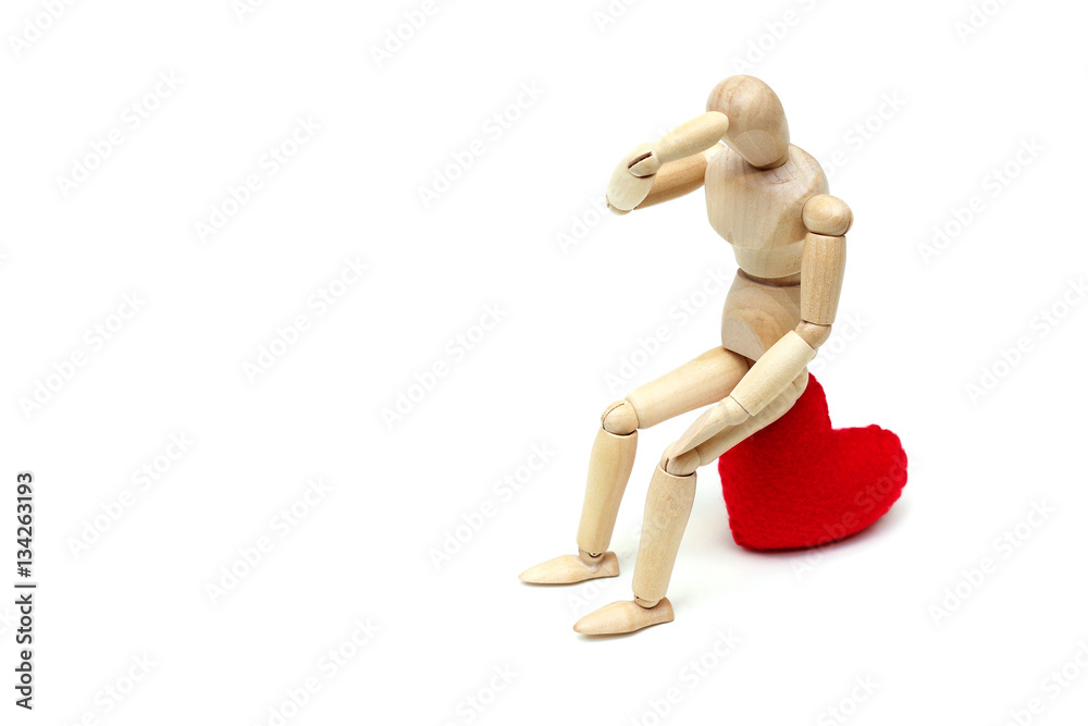 Wood Figure Mannequin sitting sadly on a red heart waiting for love Wood Figure Mannequin sitting sadly on a red heart waiting for love