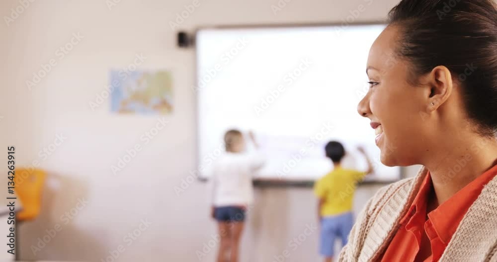 Portrait of school teacher standing in classroom Portrait of school teacher standing in classroom