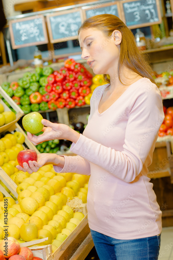 woman choosing apples