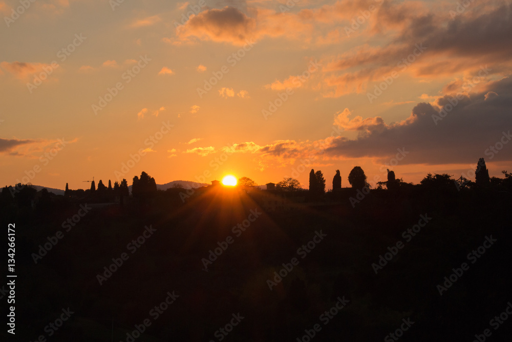 The lights of the sun. Sunset in Florence. Tuscany. Italy. The lights of the sun. Sunset in Florence. Tuscany. Italy.