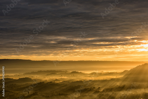 Breathtaking landscape with mist in the morning and sunbeam over hill
