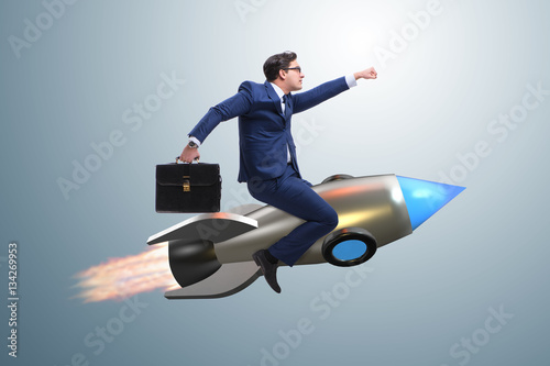 Businessman flying on rocket in business concept photo