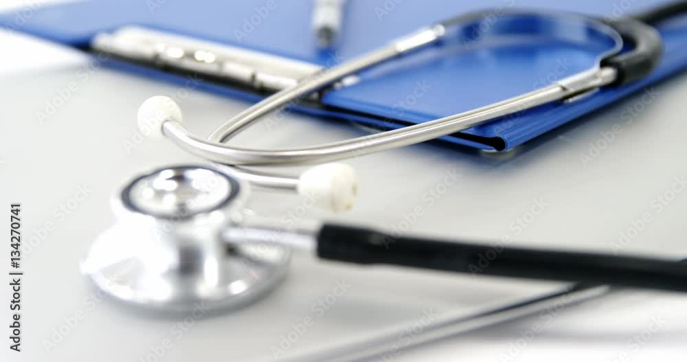 Close-up of folder file and pen with stethoscope Close-up of folder file and pen with stethoscope