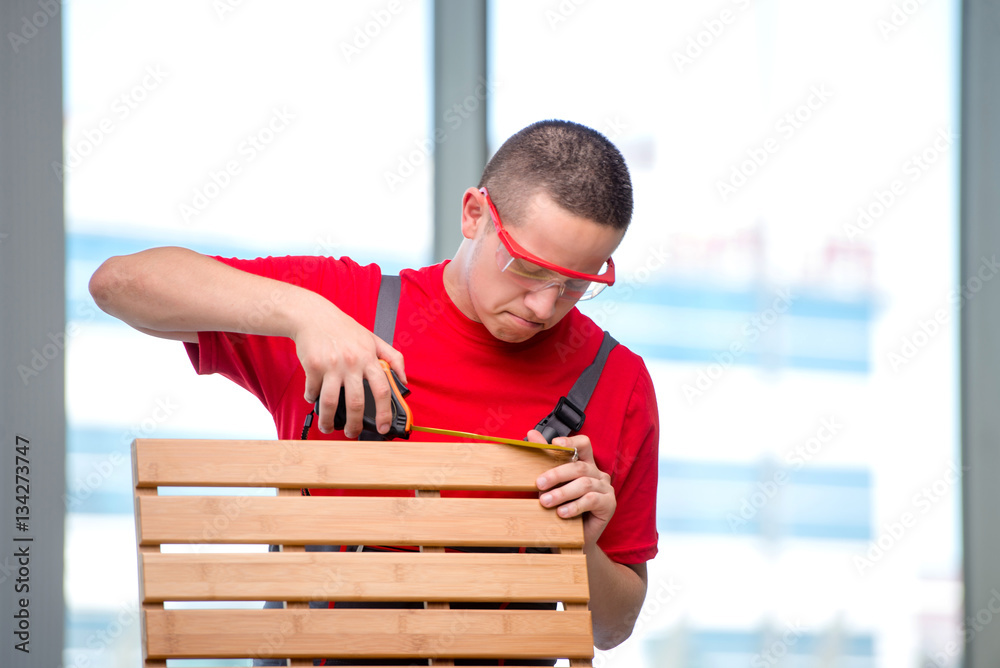 Young furniture carpenter in industrial concept Young furniture carpenter in industrial concept