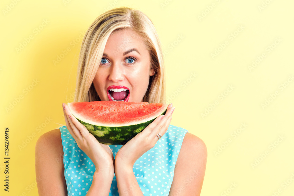 Happy young woman holding watermelon Happy young woman holding watermelon