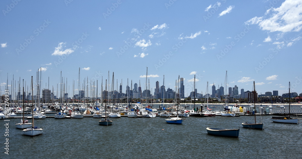 Melbourne skyline from St Kilda (Victoria Australia). View from a wooden jetty over the city of Melbourne in the Port Phillip Bay in Victoria and many yachts on the quay.