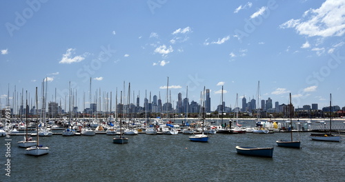 Melbourne skyline from St Kilda (Victoria Australia). View from a wooden jetty over the city of Melbourne in the Port Phillip Bay in Victoria and many yachts on the quay. © katacarix