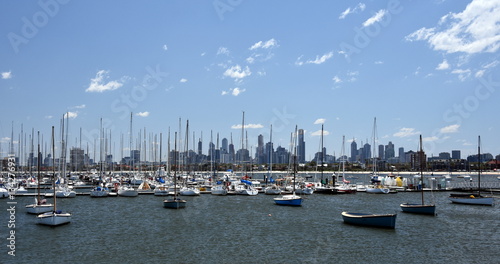 Melbourne skyline from St Kilda (Victoria Australia). View from a wooden jetty over the city of Melbourne in the Port Phillip Bay in Victoria and many yachts on the quay.