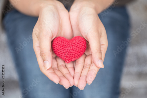giving love. red heart in women her hand photo