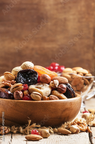 Healthy food: nuts and dried fruit, vintage wooden background, s
