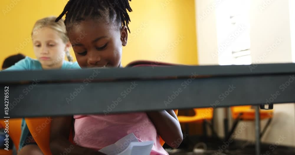 Schoolgirl cheating while writing a exam in class