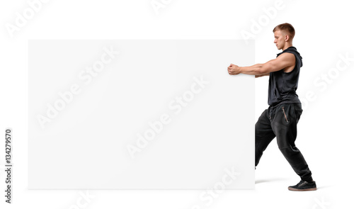 Muscular man holding a clear white display board with his fists. © gearstd