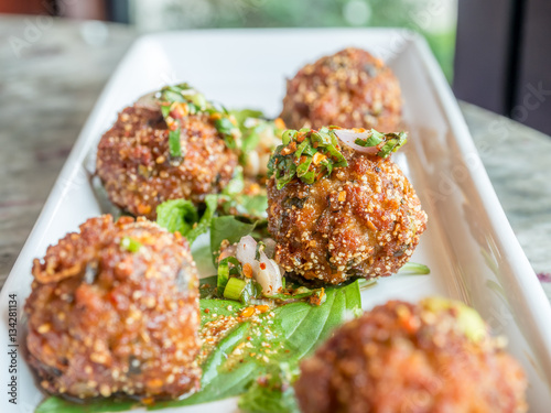 Thai spicy meat ball on white dish photo