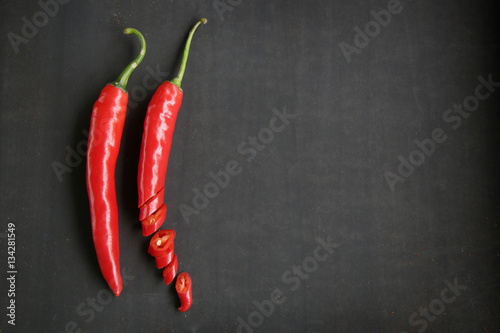 Chili peppers on a black background - lot of blank space