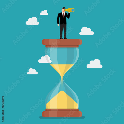 Businessman with monocular on sandglass
