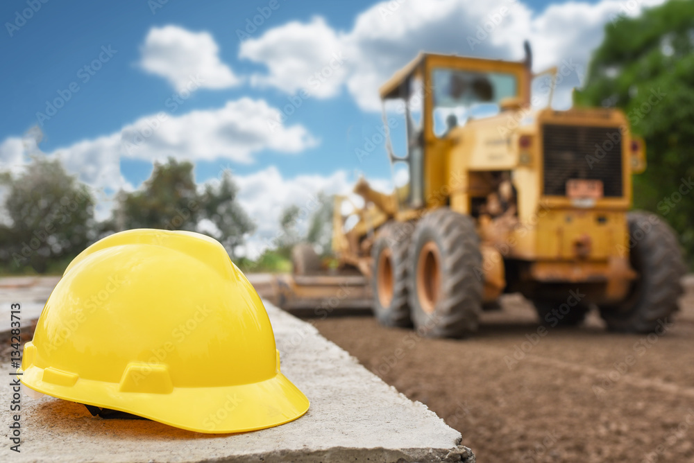 Yellow safety helmet with worker on express way construction site Yellow safety helmet with worker on express way construction site