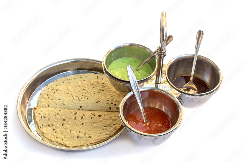 Indian bread served with traditional assortment of sauces Indian bread served with traditional assortment of sauces