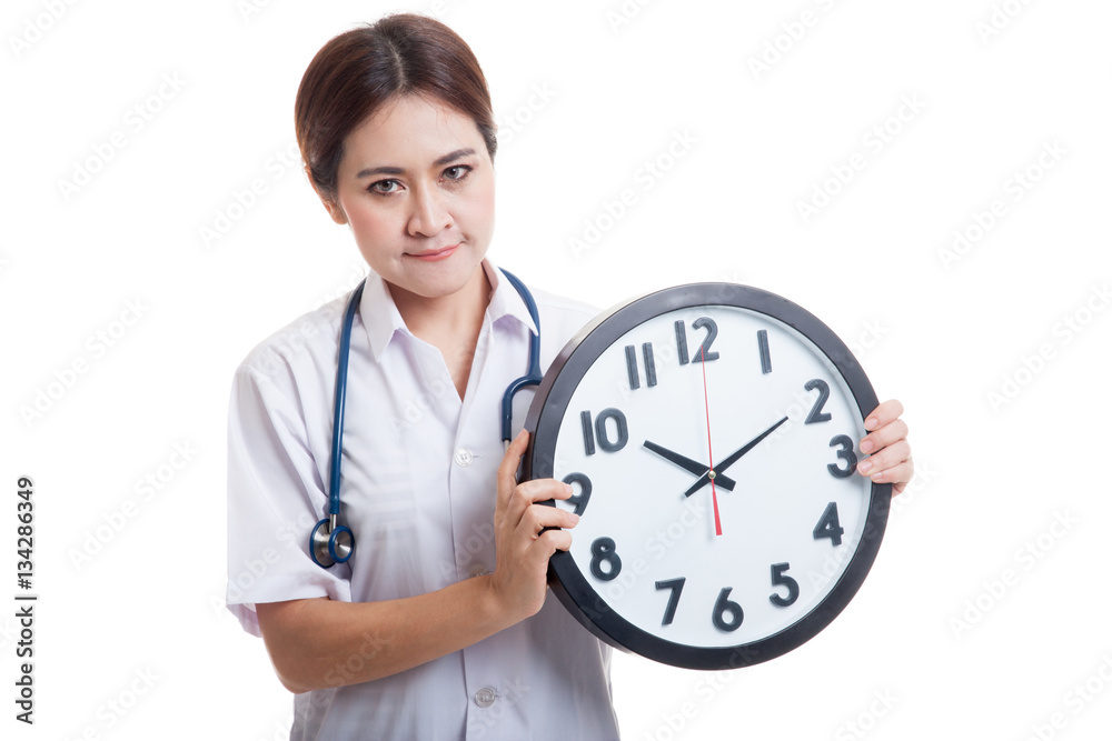Frustrated Young Asian female doctor with a clock. Frustrated Young Asian female doctor with a clock.