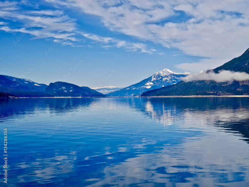 Blue lake and blue snowy mountains. Upper Arrow lake. Columbia River.  Selkirk and Monashee Mountains.  Keenleyside Dam. Castlegar. Revelstoke. British Columbia. Canada.