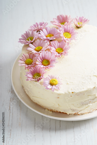 sweet white buttercream cake with pink flowers on top