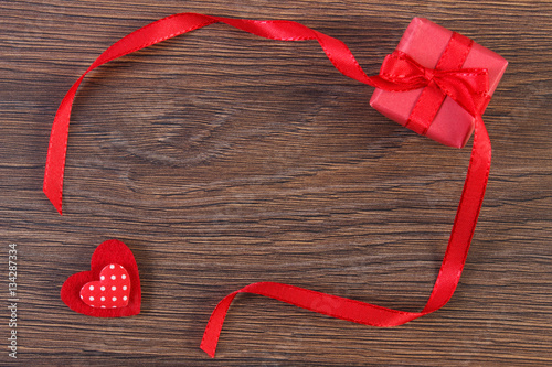 Wrapped gift with ribbon and heart for Valentines Day, copy space for text
