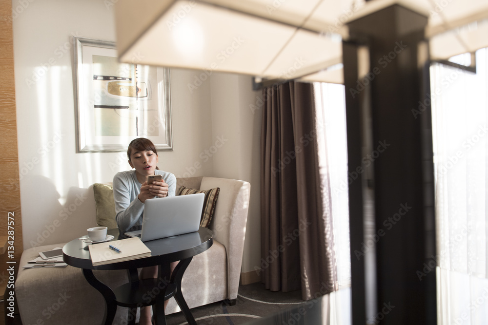 A woman is killing time with a smartphone A woman is killing time with a smartphone