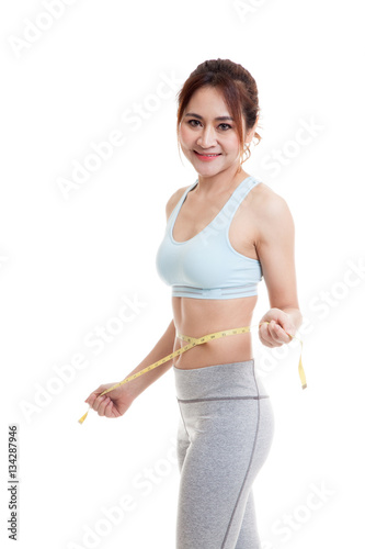 Beautiful Asian healthy girl measuring her waist. © halfbottle