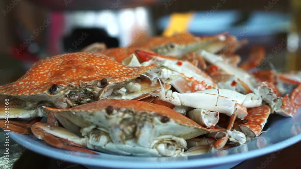 Thai seafood dish. Orange cooked steamed blue crabs on big plate Thai seafood dish. Orange cooked steamed blue crabs on big plate