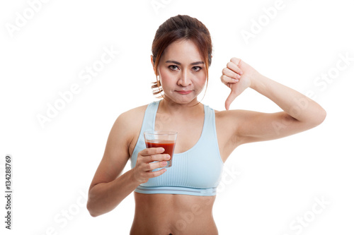 Beautiful healthy Asian girl hate tomato juice thumbs down.