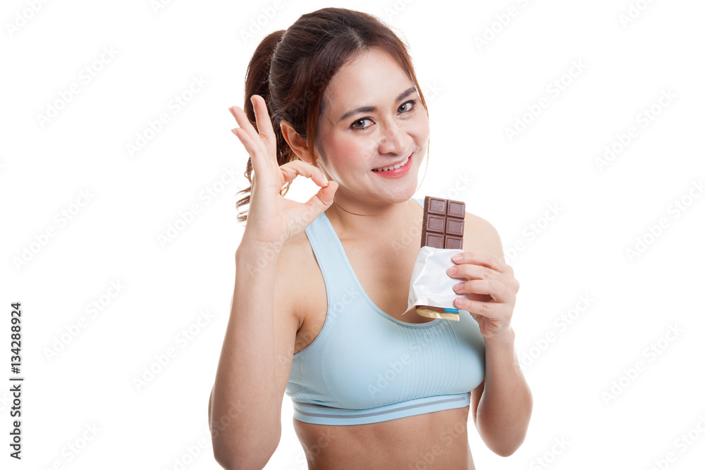 Beautiful healthy Asian girl show OK with chocolate. Beautiful healthy Asian girl show OK with chocolate.
