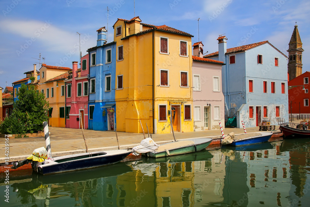 Colorful houses by canal in Burano, Venice, Italy.