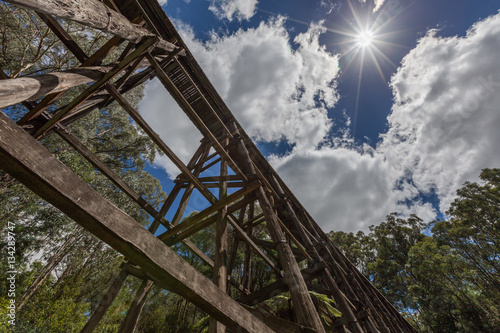 Old trestle bridge on hot summer day in Australia.