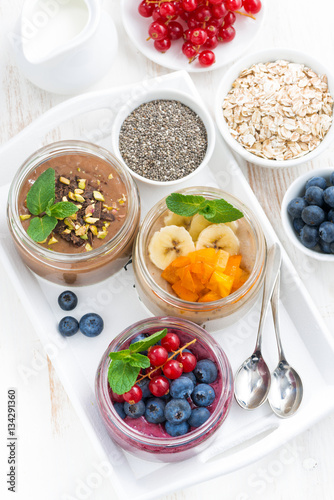 assorted breakfast of chia seeds and fruits in jars 