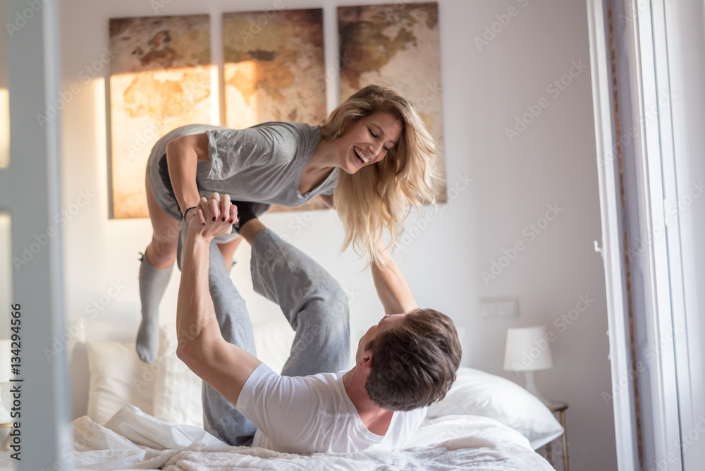 couple playing and having fun at home on bed couple playing and having fun at home on bed