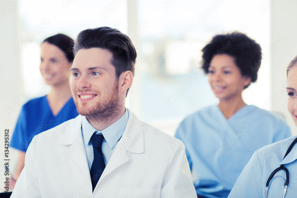 happy doctor over group of medics at hospital happy doctor over group of medics at hospital