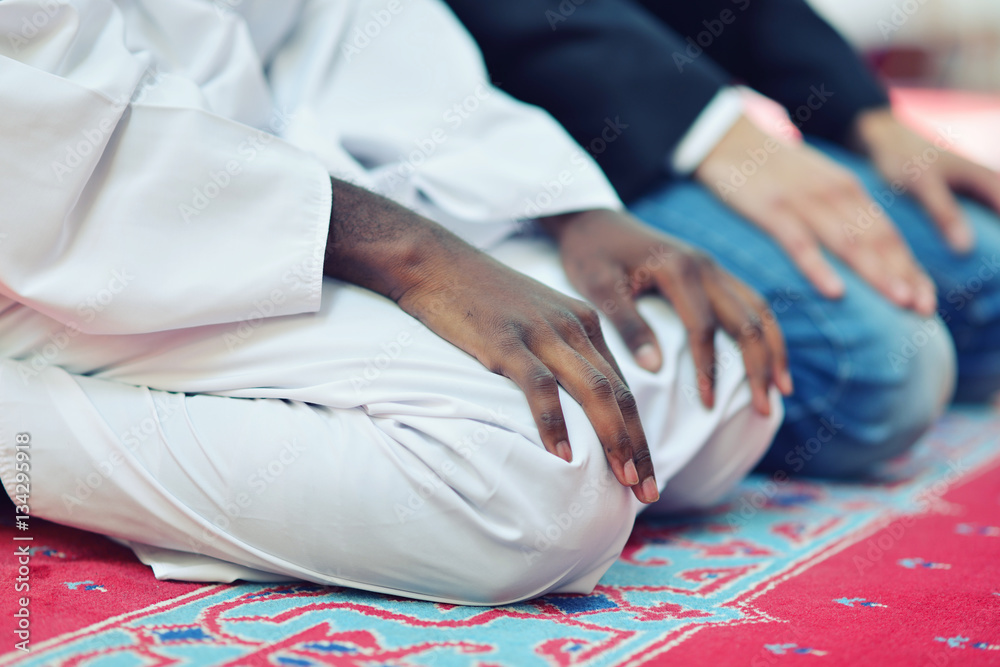 Fototapeta premium Two religious muslim man praying together inside the mosque