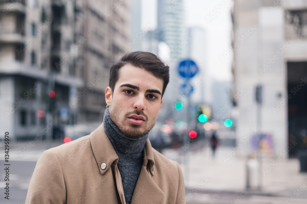Beautiful young man posing in an urban context Beautiful young man posing in an urban context