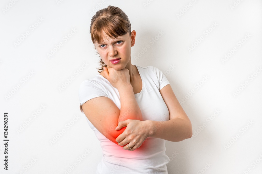 Woman with elbow pain is holding her aching arm Woman with elbow pain is holding her aching arm