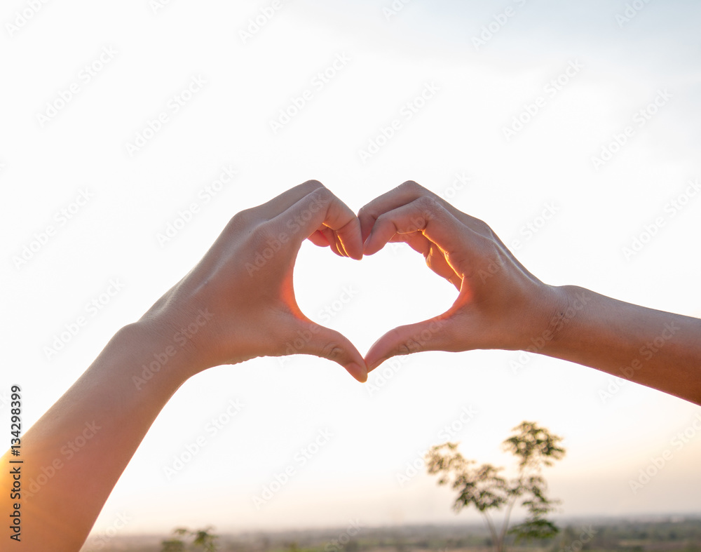 woman holding hands in heart shape framing on nat woman holding hands in heart shape framing on nat